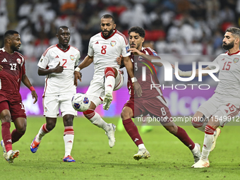 Jassem Gaber (#8) of Qatar battles for the ball with Tahnoon Hamdan (#8) of the United Arab Emirates during the qualification 3rd round for...