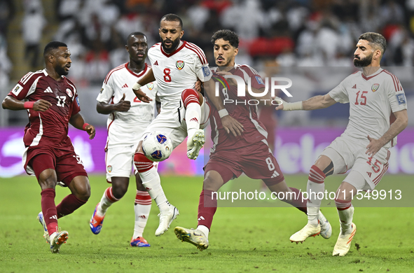 Jassem Gaber (#8) of Qatar battles for the ball with Tahnoon Hamdan (#8) of the United Arab Emirates during the qualification 3rd round for...