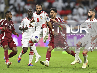 Jassem Gaber (#8) of Qatar battles for the ball with Tahnoon Hamdan (#8) of the United Arab Emirates during the qualification 3rd round for...