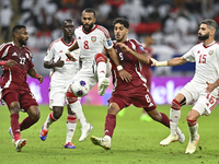 Jassem Gaber (#8) of Qatar battles for the ball with Tahnoon Hamdan (#8) of the United Arab Emirates during the qualification 3rd round for...