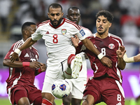 Jassem Gaber (#8) of Qatar battles for the ball with Tahnoon Hamdan (#8) of the United Arab Emirates during the qualification 3rd round for...