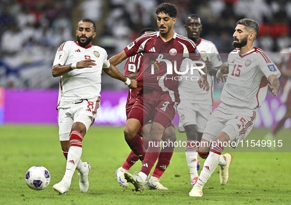 Jassem Gaber (#8) of Qatar battles for the ball with Tahnoon Hamdan (#8) of the United Arab Emirates during the qualification 3rd round for...