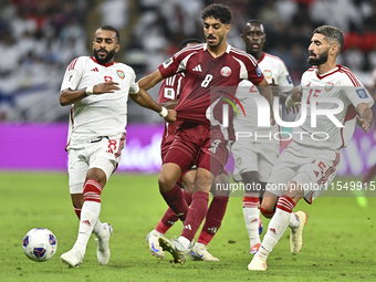 Jassem Gaber (#8) of Qatar battles for the ball with Tahnoon Hamdan (#8) of the United Arab Emirates during the qualification 3rd round for...