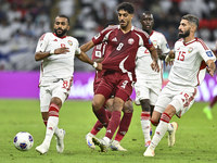 Jassem Gaber (#8) of Qatar battles for the ball with Tahnoon Hamdan (#8) of the United Arab Emirates during the qualification 3rd round for...