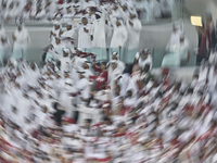 Qatar team supporters cheer for their team during the qualification 3rd round for the FIFA World Cup 2026 group A match between Qatar and Un...