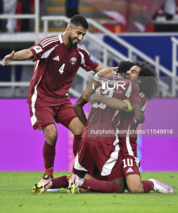 Ibrahim Mohammadali of Qatar celebrates with his teammate after scoring during the qualification 3rd round for the FIFA World Cup 2026 group...