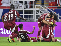 Ibrahim Mohammadali (second from right) of Qatar celebrates with his teammate after scoring during the qualification third round for the FIF...