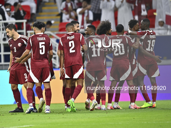 Ibrahim Mohammadali (second from right) of Qatar celebrates with his teammate after scoring during the qualification third round for the FIF...