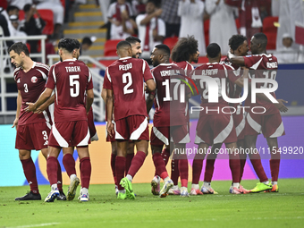 Ibrahim Mohammadali (second from right) of Qatar celebrates with his teammate after scoring during the qualification third round for the FIF...