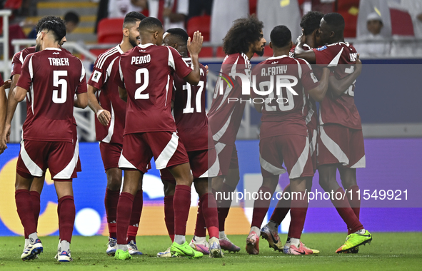 Ibrahim Mohammadali (second from right) of Qatar celebrates with his teammate after scoring during the qualification third round for the FIF...