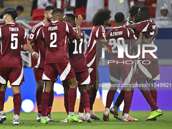 Ibrahim Mohammadali (second from right) of Qatar celebrates with his teammate after scoring during the qualification third round for the FIF...