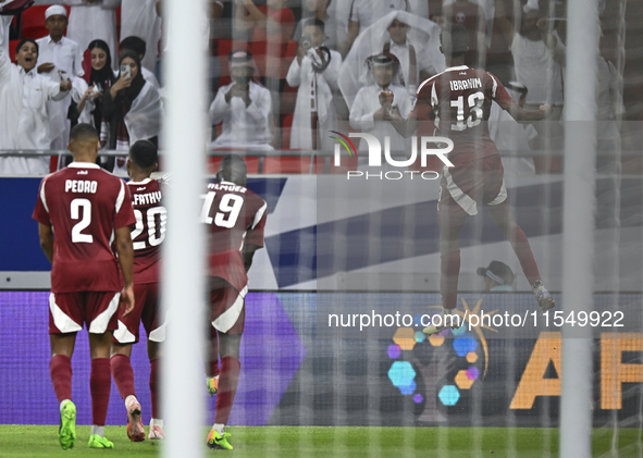 Ibrahim Mohammadali of Qatar celebrates with his teammate after scoring during the qualification 3rd round for the FIFA World Cup 2026 group...