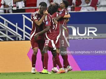 Ibrahim Mohammadali of Qatar celebrates with his teammate after scoring during the qualification 3rd round for the FIFA World Cup 2026 group...