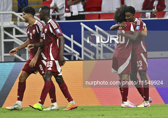 Ibrahim Mohammadali of Qatar celebrates with his teammate after scoring during the qualification 3rd round for the FIFA World Cup 2026 group...