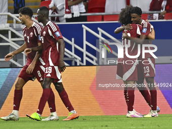 Ibrahim Mohammadali of Qatar celebrates with his teammate after scoring during the qualification 3rd round for the FIFA World Cup 2026 group...