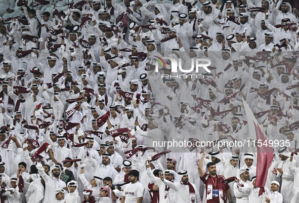 Qatar team supporters cheer for their team during the qualification 3rd round for the FIFA World Cup 2026 group A match between Qatar and Un...