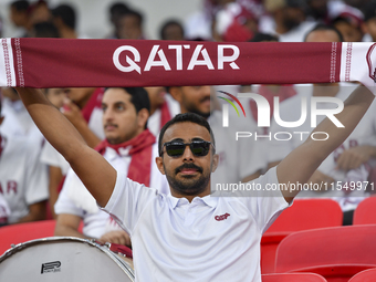 Qatar team supporters cheer for their team during the qualification 3rd round for the FIFA World Cup 2026 group A match between Qatar and Un...