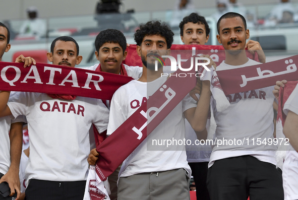 Qatar team supporters cheer for their team during the qualification 3rd round for the FIFA World Cup 2026 group A match between Qatar and Un...