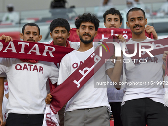 Qatar team supporters cheer for their team during the qualification 3rd round for the FIFA World Cup 2026 group A match between Qatar and Un...