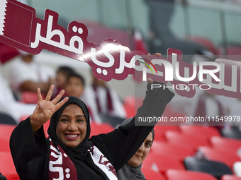 Qatar team supporters cheer for their team during the qualification 3rd round for the FIFA World Cup 2026 group A match between Qatar and Un...