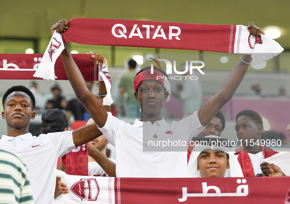 Qatar team supporters cheer for their team during the qualification 3rd round for the FIFA World Cup 2026 group A match between Qatar and Un...