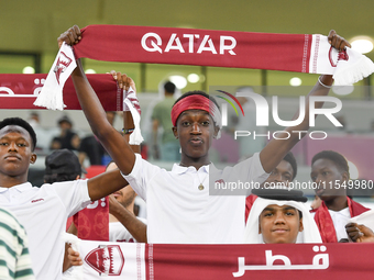 Qatar team supporters cheer for their team during the qualification 3rd round for the FIFA World Cup 2026 group A match between Qatar and Un...