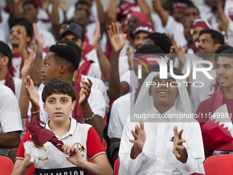 Qatar team supporters cheer for their team during the qualification 3rd round for the FIFA World Cup 2026 group A match between Qatar and Un...