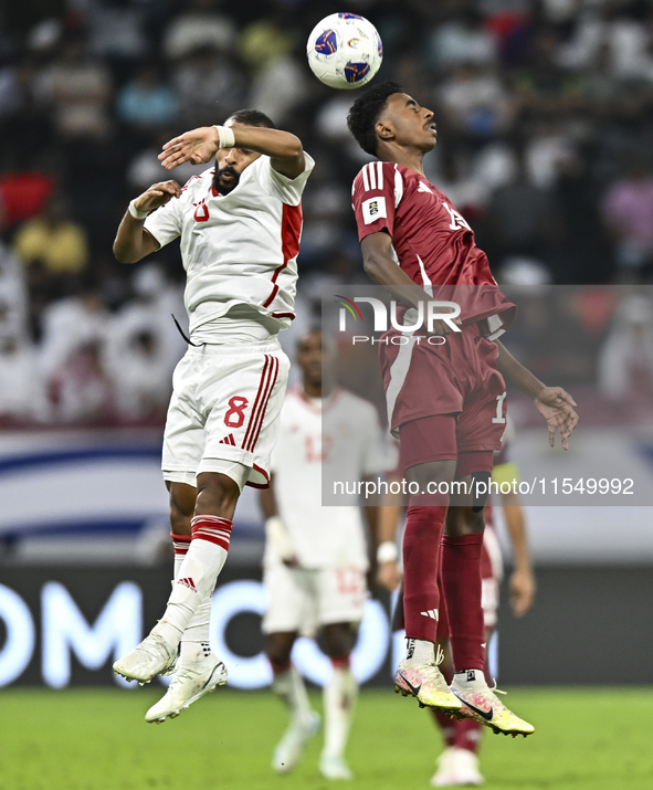 Ibrahim Mohammadali of Qatar battles for the ball with Tahnoon Hamdan of the United Arab Emirates during the qualification 3rd round for the...