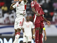 Ibrahim Mohammadali of Qatar battles for the ball with Tahnoon Hamdan of the United Arab Emirates during the qualification 3rd round for the...