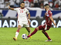 Mohammed Waad of Qatar battles for the ball with Khaled Aldhanhani of the United Arab Emirates during the qualification 3rd round for the FI...