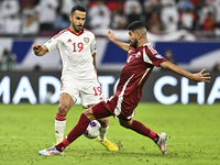 Mohammed Waad of Qatar battles for the ball with Khaled Aldhanhani of the United Arab Emirates during the qualification 3rd round for the FI...