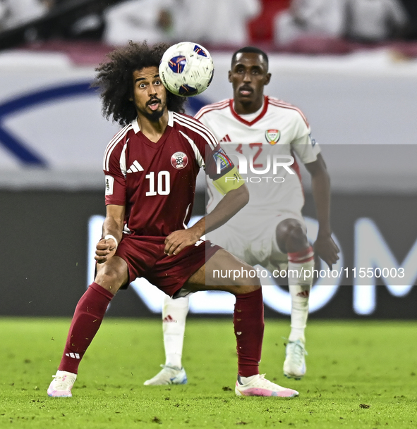 Akram Afif of Qatar battles for the ball with Khalifa Alhammadi of the United Arab Emirates during the qualification 3rd round for the FIFA...