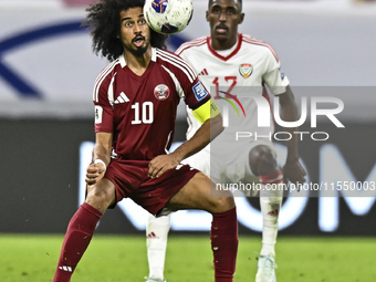 Akram Afif of Qatar battles for the ball with Khalifa Alhammadi of the United Arab Emirates during the qualification 3rd round for the FIFA...