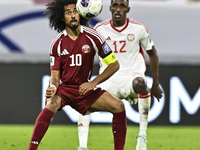 Akram Afif of Qatar battles for the ball with Khalifa Alhammadi of the United Arab Emirates during the qualification 3rd round for the FIFA...