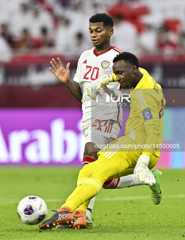 Meshaal Barsham of Qatar battles for the ball with Yahya Alghassani of the United Arab Emirates during the qualification 3rd round for the F...