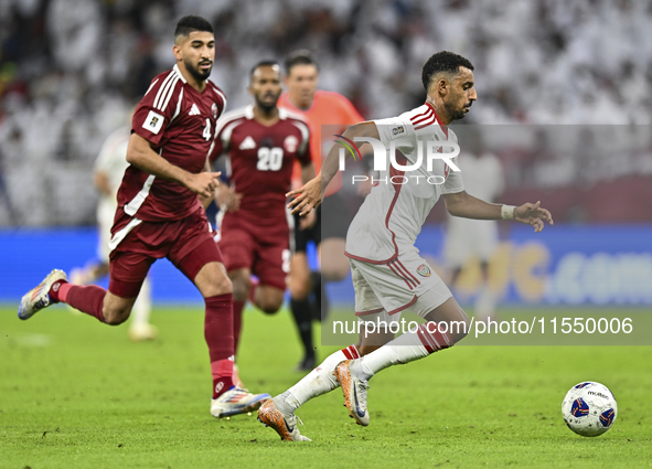 Mohammed Waad of Qatar battles for the ball with Harib Abdalla of the United Arab Emirates during the qualification 3rd round for the FIFA W...