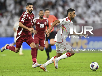 Mohammed Waad of Qatar battles for the ball with Harib Abdalla of the United Arab Emirates during the qualification 3rd round for the FIFA W...