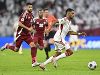 Mohammed Waad of Qatar battles for the ball with Harib Abdalla of the United Arab Emirates during the qualification 3rd round for the FIFA W...