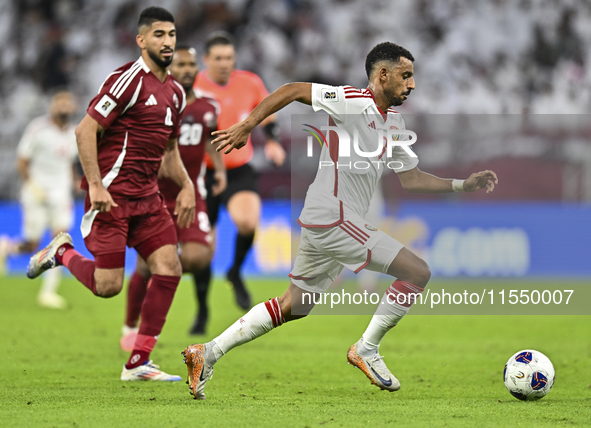 Mohammed Waad of Qatar battles for the ball with Harib Abdalla of the United Arab Emirates during the qualification 3rd round for the FIFA W...