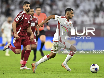 Mohammed Waad of Qatar battles for the ball with Harib Abdalla of the United Arab Emirates during the qualification 3rd round for the FIFA W...