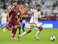 Mohammed Waad of Qatar battles for the ball with Harib Abdalla of the United Arab Emirates during the qualification 3rd round for the FIFA W...