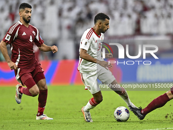 Mohammed Waad of Qatar battles for the ball with Harib Abdalla of the United Arab Emirates during the qualification 3rd round for the FIFA W...