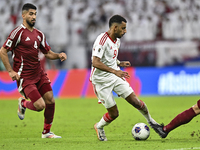 Mohammed Waad of Qatar battles for the ball with Harib Abdalla of the United Arab Emirates during the qualification 3rd round for the FIFA W...