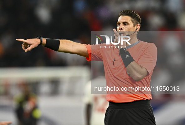 Australian referee Shaun Evans gestures during the qualification 3rd round for the FIFA World Cup 2026 group A match between Qatar and Unite...