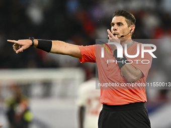 Australian referee Shaun Evans gestures during the qualification 3rd round for the FIFA World Cup 2026 group A match between Qatar and Unite...