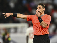 Australian referee Shaun Evans gestures during the qualification 3rd round for the FIFA World Cup 2026 group A match between Qatar and Unite...