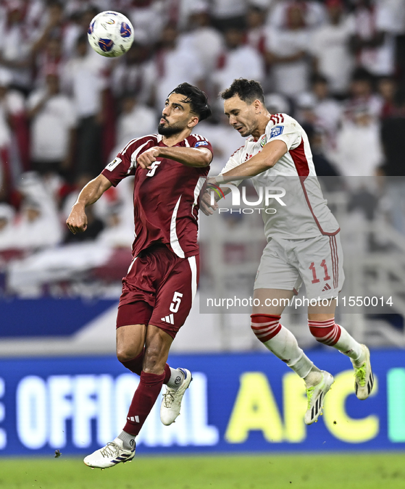 Tarek Salman of Qatar battles for the ball with Caio Correa of the United Arab Emirates during the qualification 3rd round for the FIFA Worl...