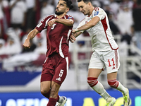 Tarek Salman of Qatar battles for the ball with Caio Correa of the United Arab Emirates during the qualification 3rd round for the FIFA Worl...