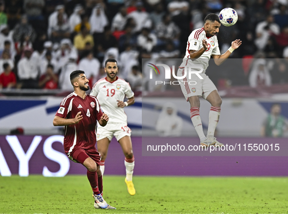 Mohammed Waad of Qatar battles for the ball with Harib Abdalla of the United Arab Emirates during the qualification 3rd round for the FIFA W...