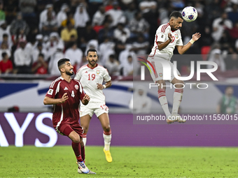 Mohammed Waad of Qatar battles for the ball with Harib Abdalla of the United Arab Emirates during the qualification 3rd round for the FIFA W...